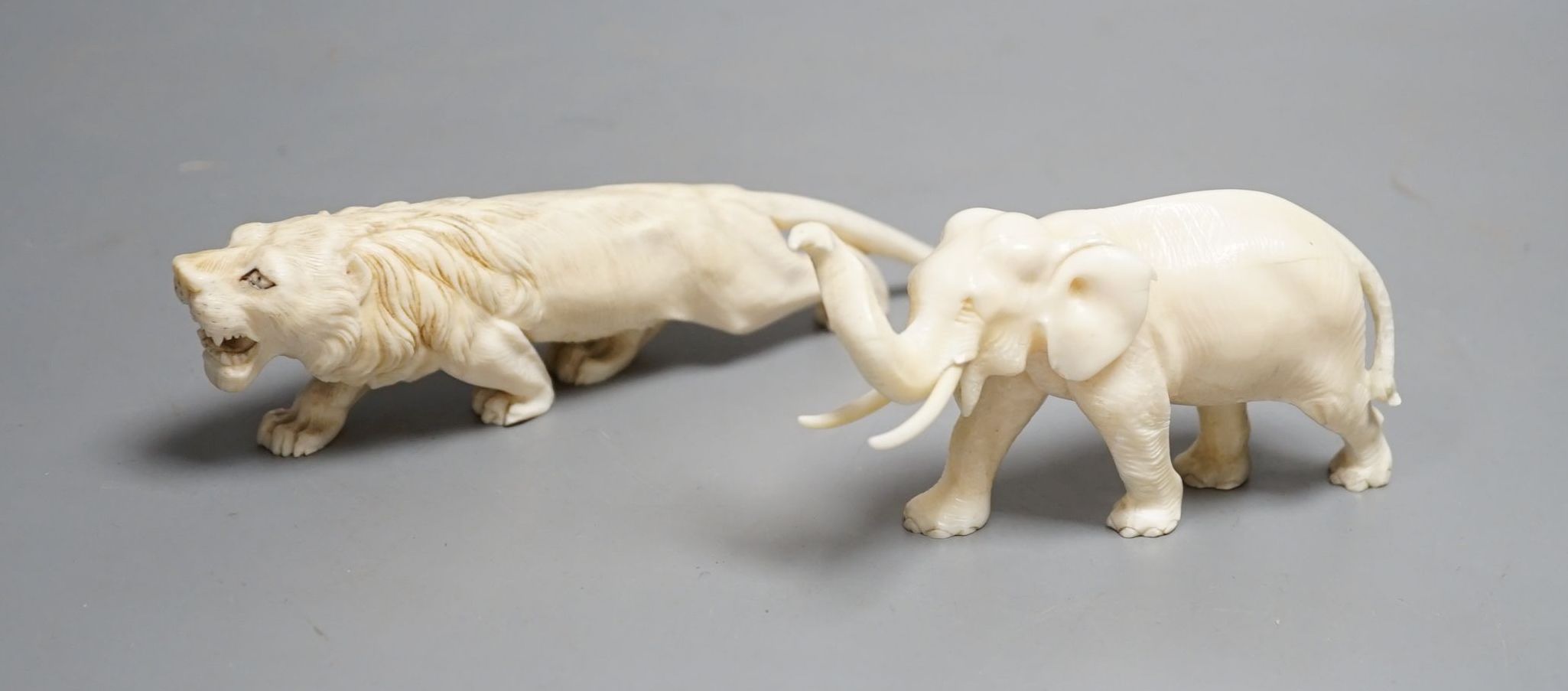 A Japanese Ivory model of an elephant and a similar Ivory model of a lion, early 20th century (2) lion 17cm long